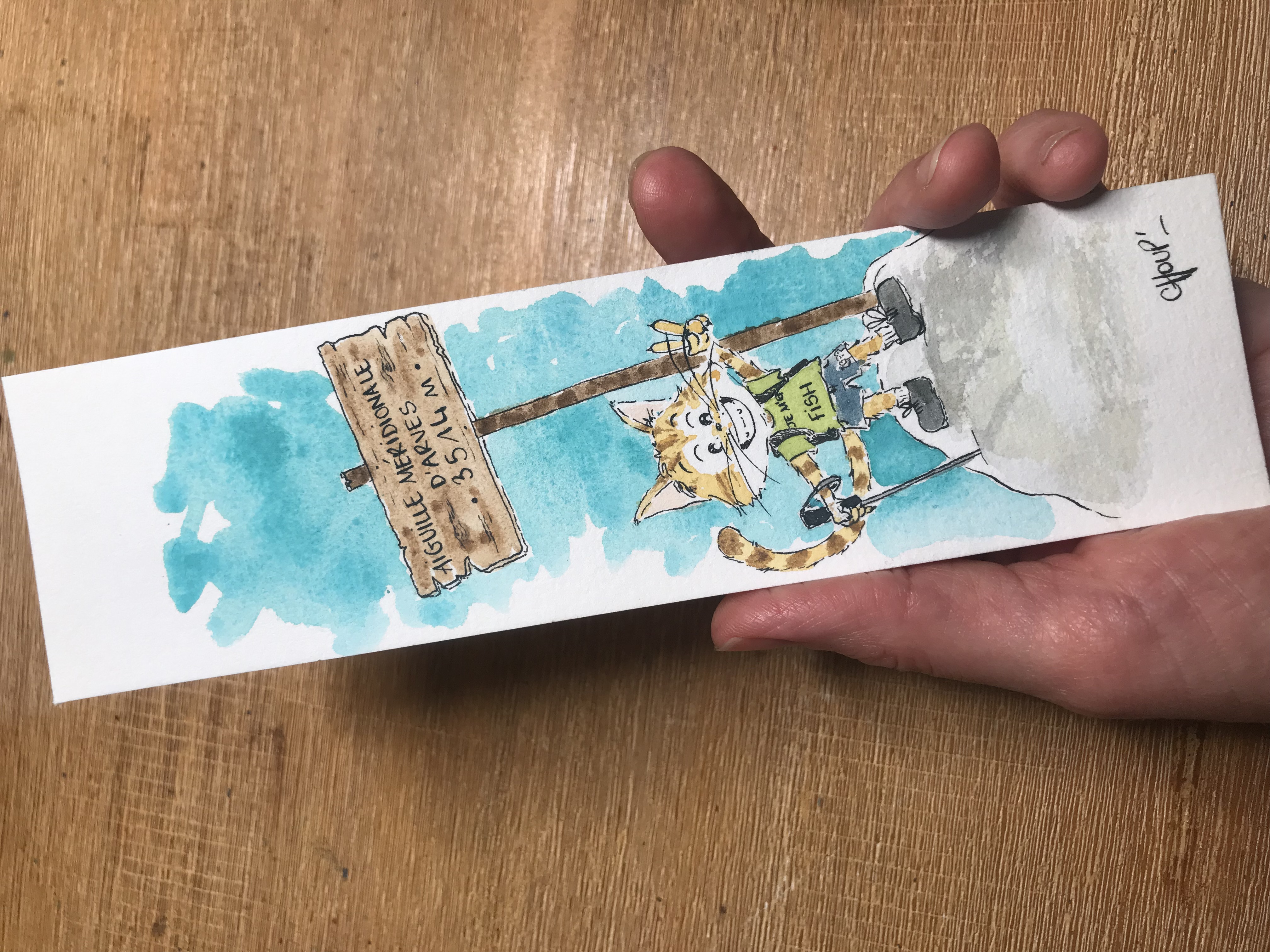 Marque page représentant un chat qui fait de la randonnée